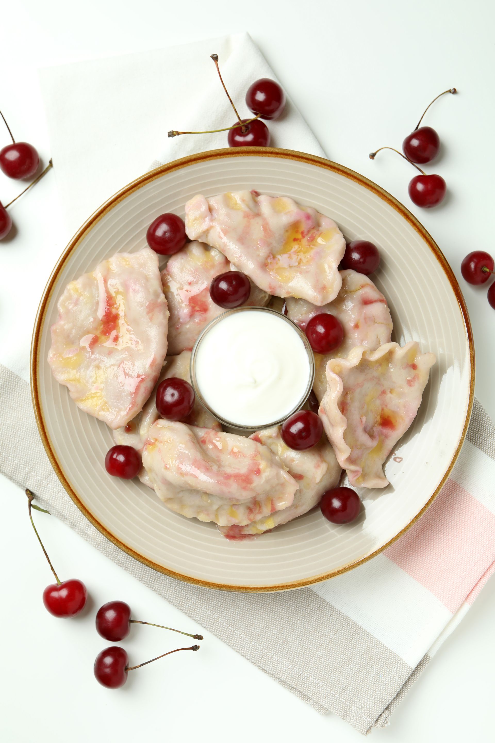 Overhead flat-lay of all ingredients for Ukrainian Vareniki with Sweet Cherry Filling laid out on a kitchen surface.