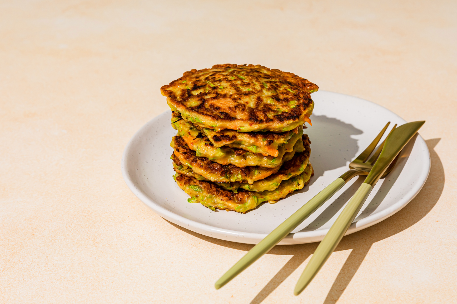 Overhead flat-lay of all ingredients for Umami-Crusted Korean Kimchi Pancakes with Sesame Leaf laid out on a kitchen surface.