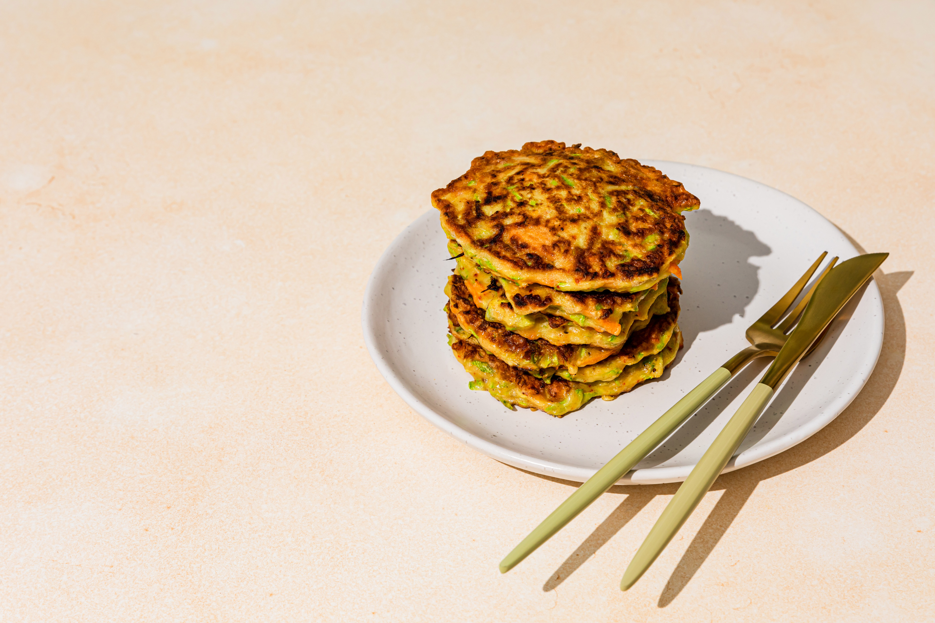 Umami-Crusted Korean Kimchi Pancakes with Sesame Leaf — Appetizer served and photographed from above