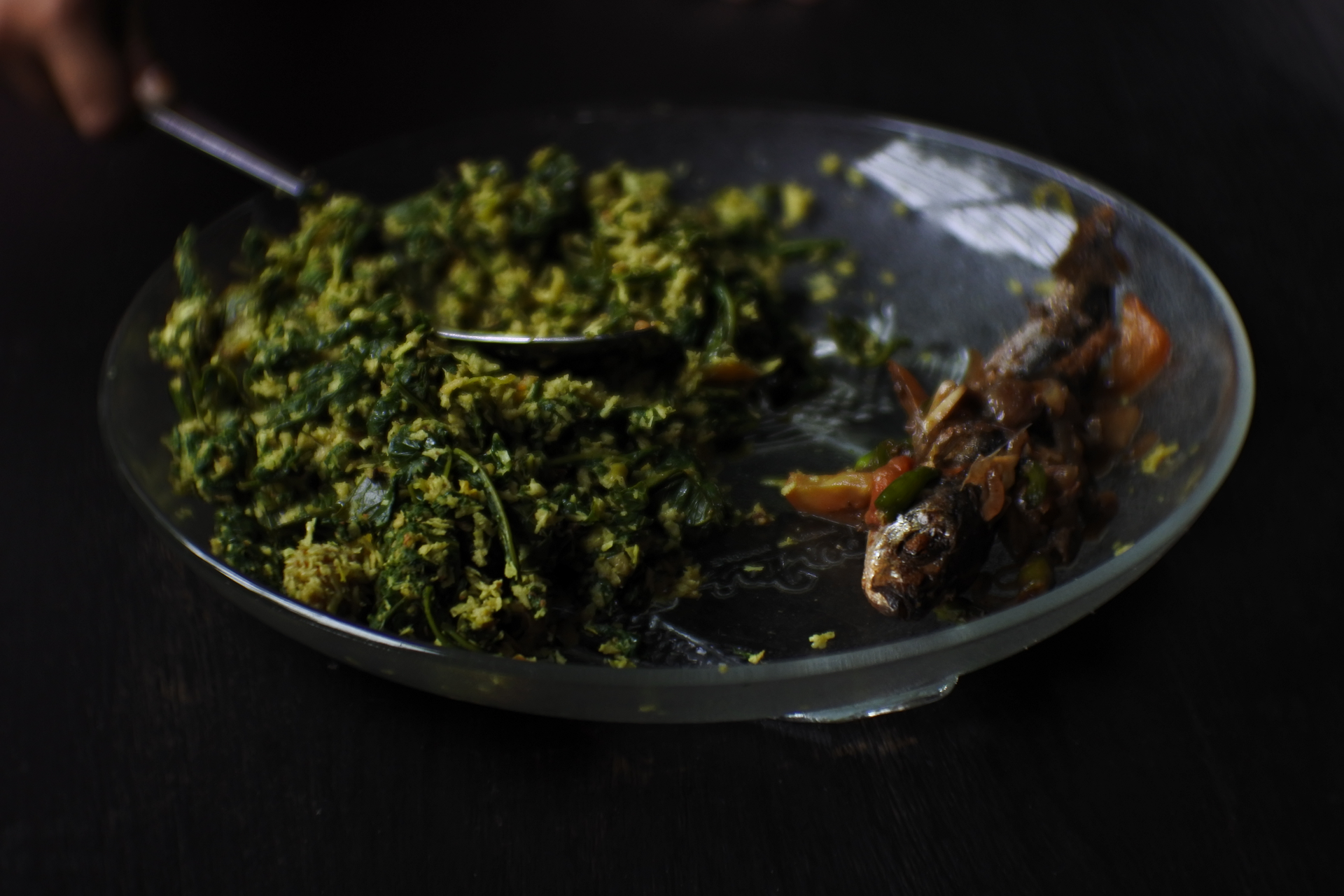 Overhead flat-lay of all ingredients for Velvety Egyptian Molokhia with Rabbit and Lemon laid out on a kitchen surface.