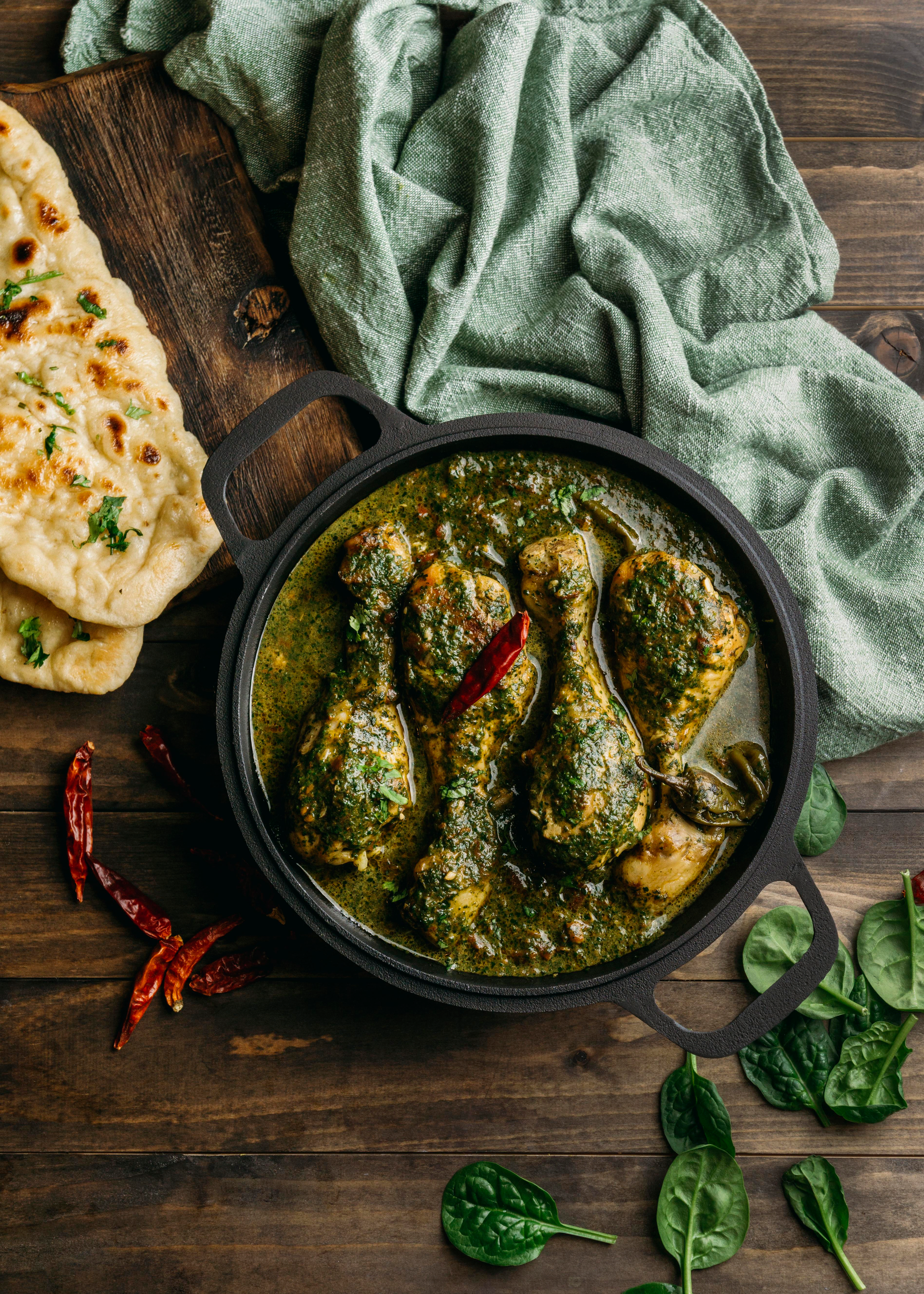 Overhead flat-lay of all ingredients for Velvety Indian Bhindi Masala with Garam Masala laid out on a kitchen surface.
