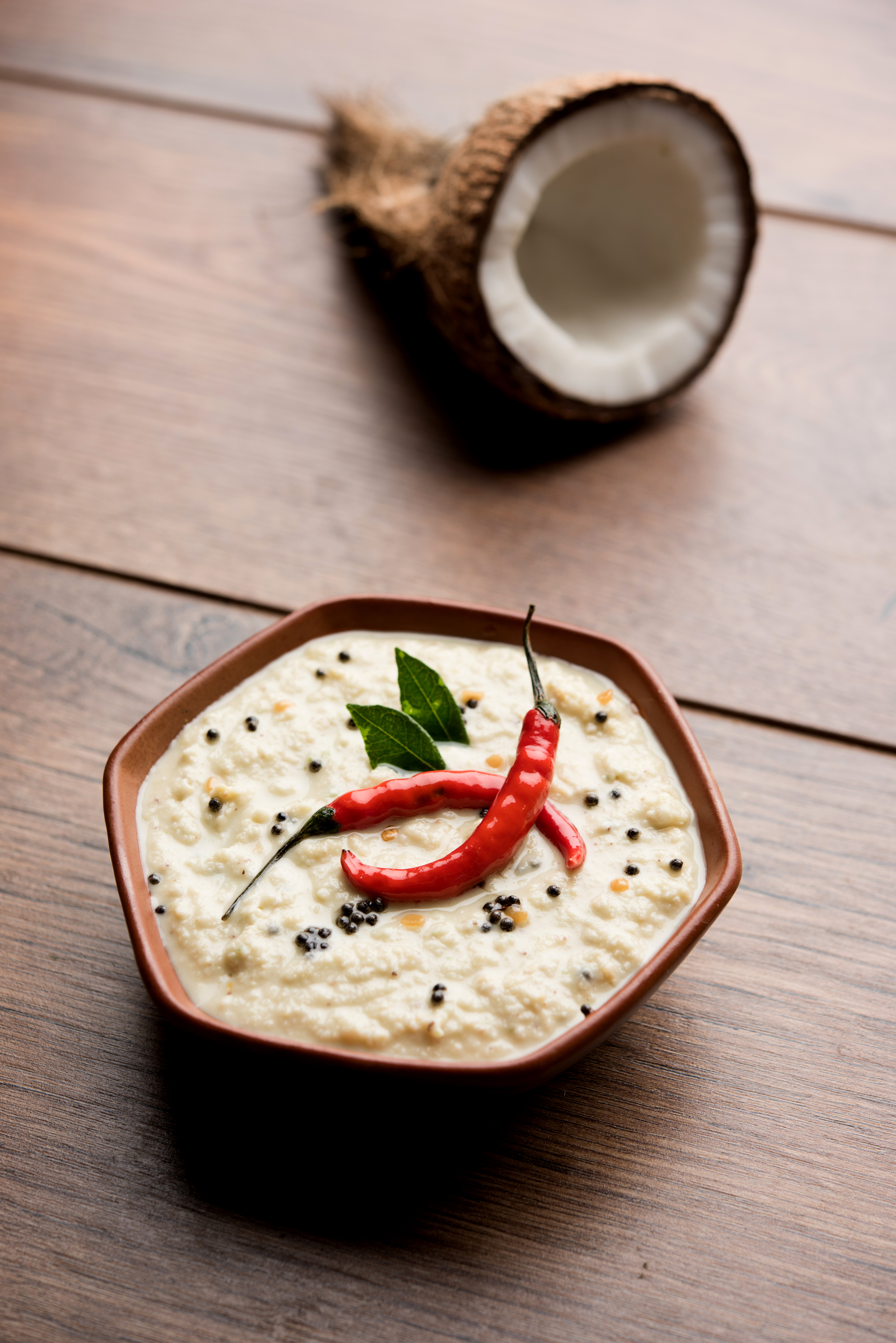 Overhead flat-lay of all ingredients for Velvety Indian Coconut Chutney with Toasted Urad Dal laid out on a kitchen surface.