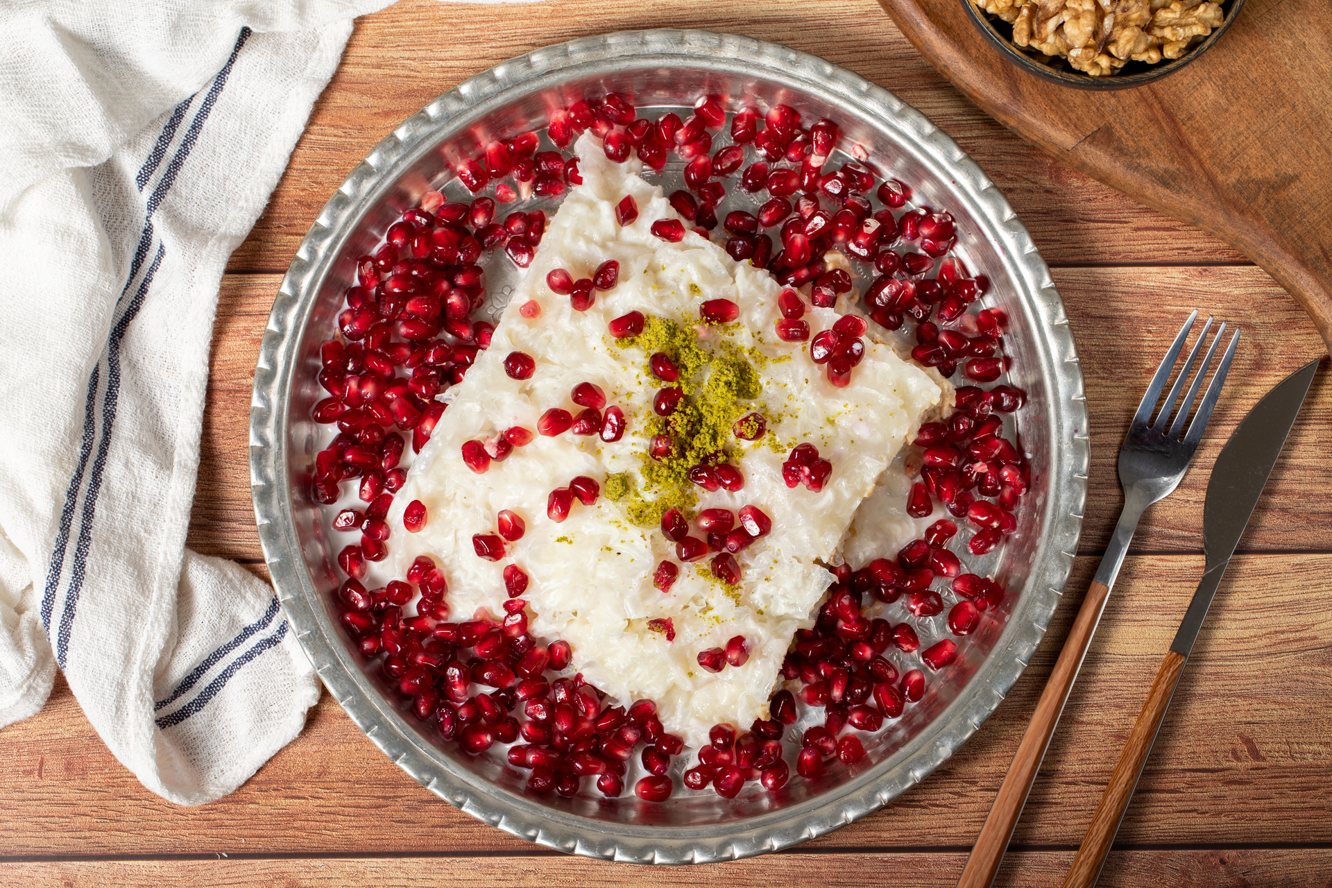Overhead flat-lay of all ingredients for Velvety Turkish Rice Pudding with Pomegranate Syrup laid out on a kitchen surface.