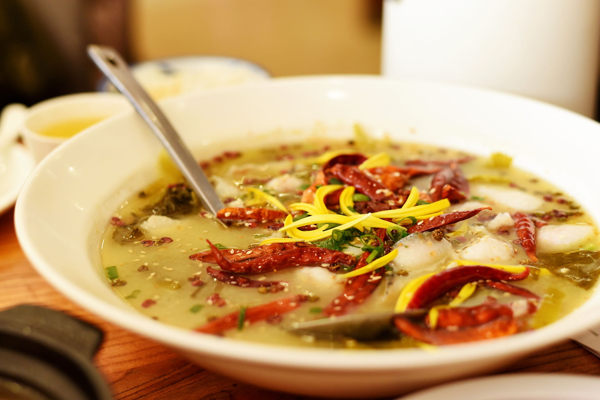 Overhead flat-lay of all ingredients for Vibrant Ecuadorian Encebollado with Cilantro-Lime Broth laid out on a kitchen surface.