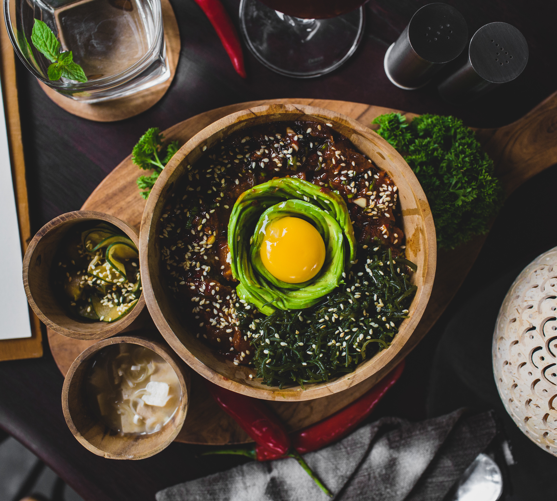 Overhead flat-lay of all ingredients for Vibrant Korean Bibimbap Bowl with Sesame Spinach laid out on a kitchen surface.