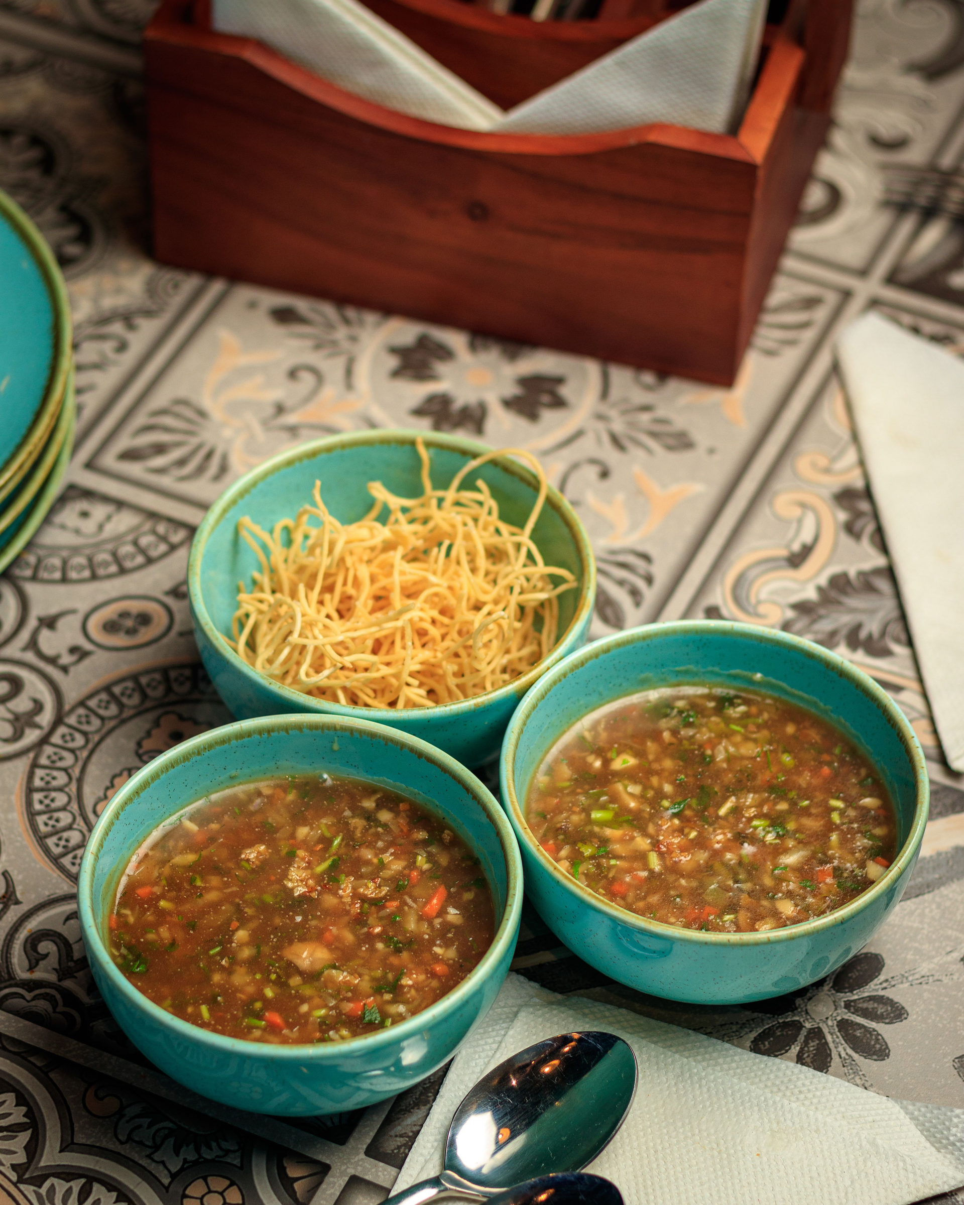 Overhead flat-lay of all ingredients for Vibrant Nepalese Gundruk Soup laid out on a kitchen surface.