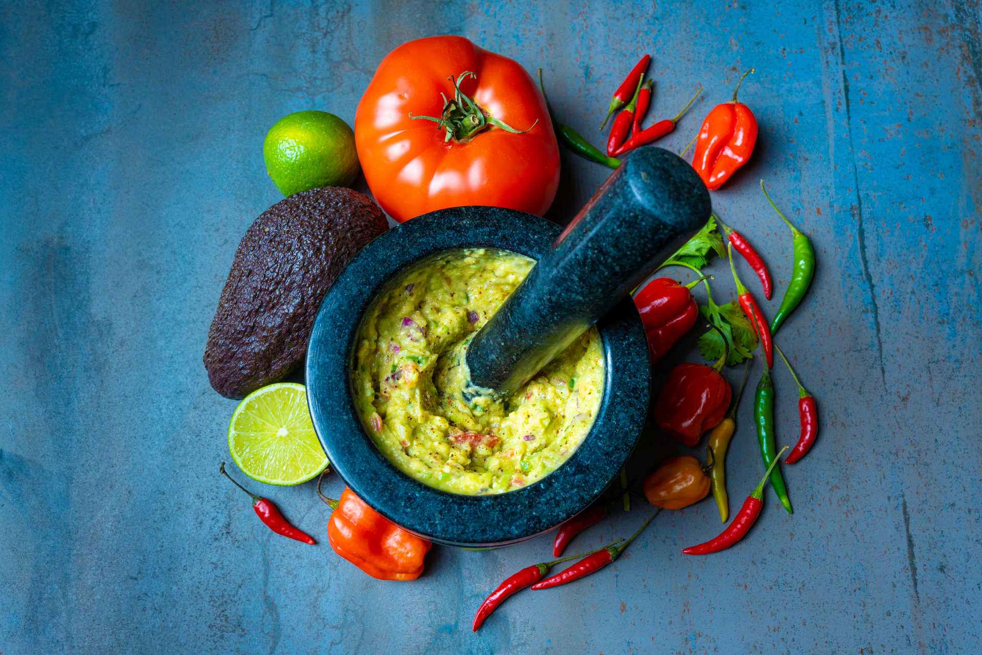 Overhead flat-lay of all ingredients for Vibrant Peruvian Huacatay Sauce with Grilled Vegetables laid out on a kitchen surface.