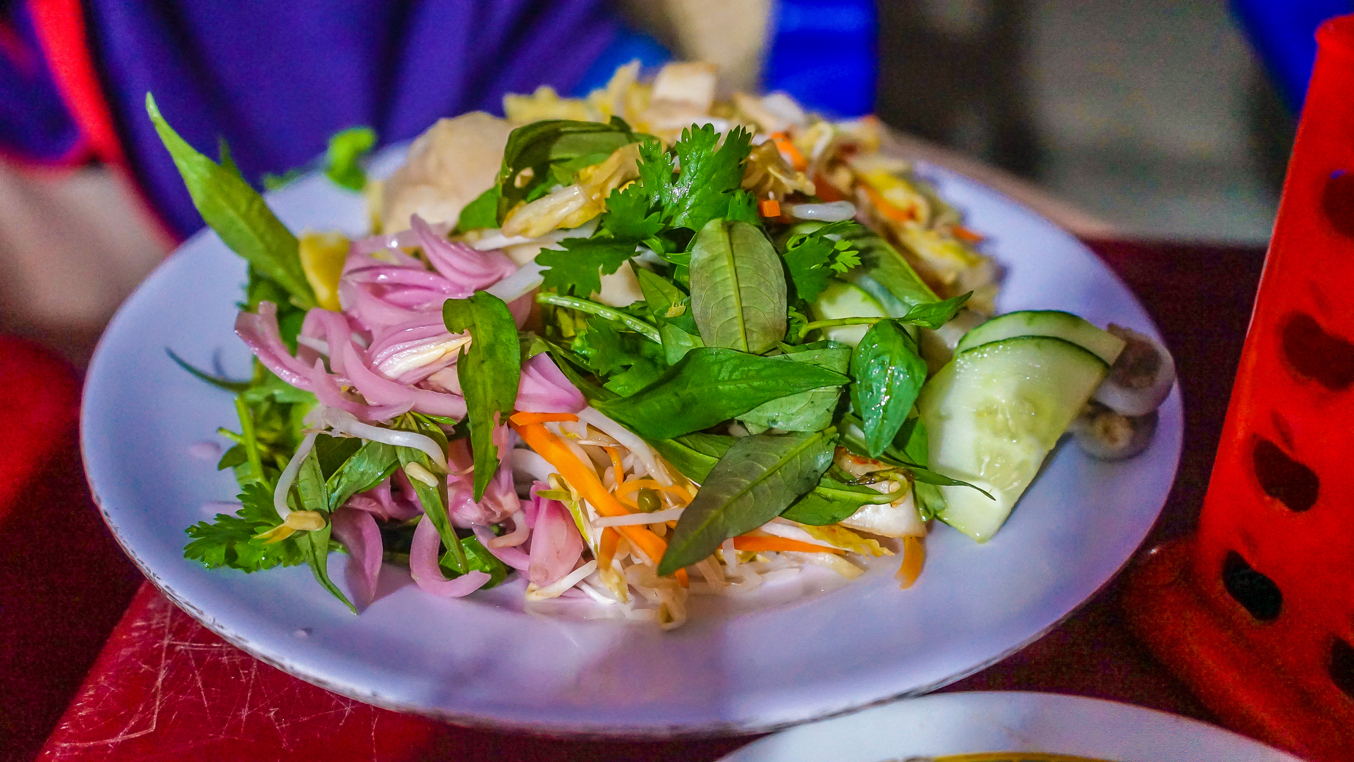 Overhead flat-lay of all ingredients for Vietnamese Banana Blossom Salad with Lime Dressing laid out on a kitchen surface.