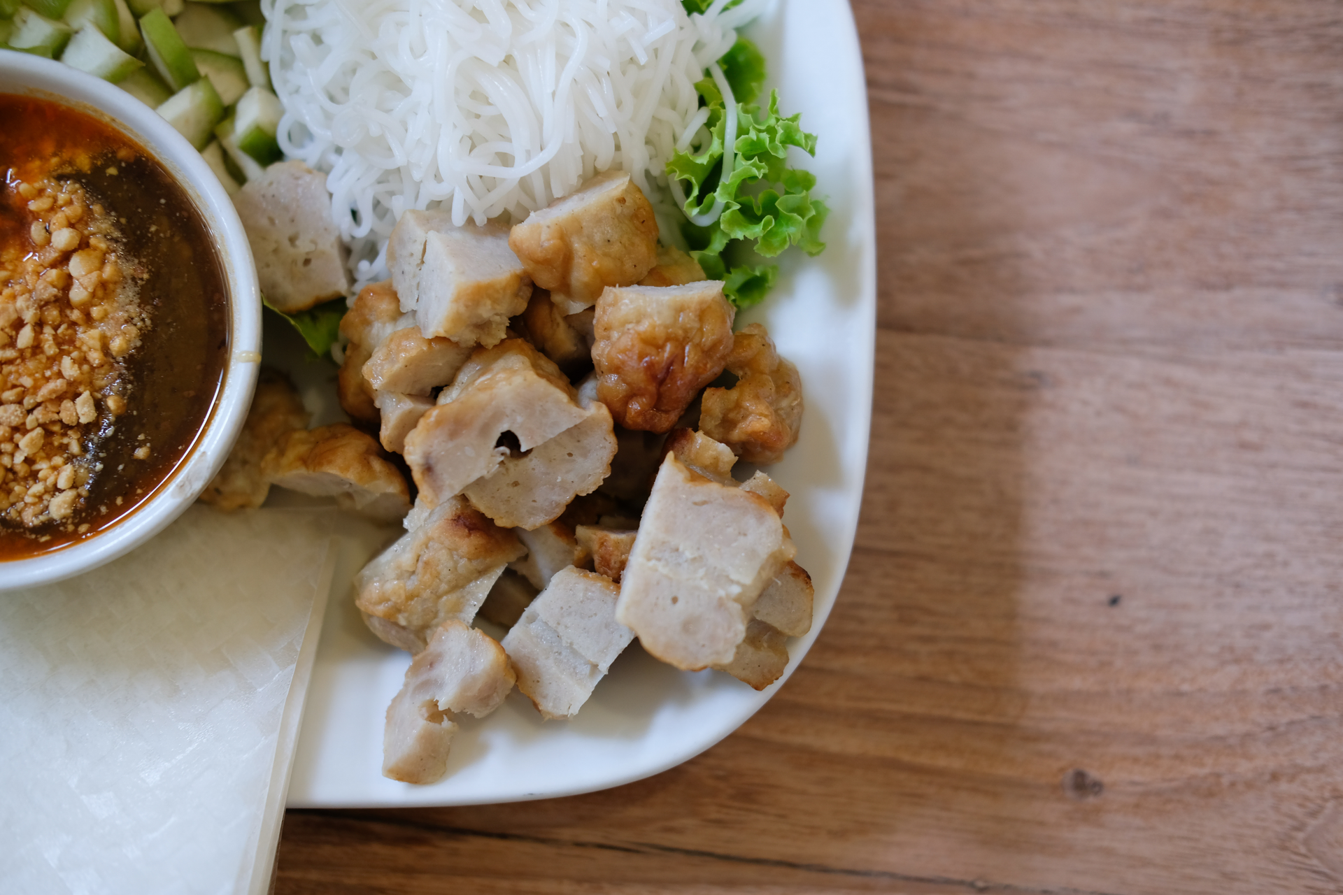 Overhead flat-lay of all ingredients for Vietnamese Bun Cha with Grilled Pork and Nuoc Cham laid out on a kitchen surface.
