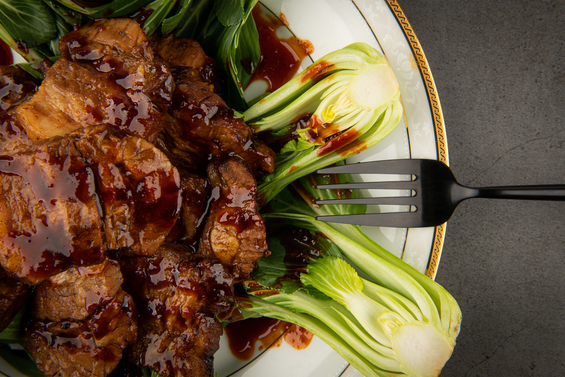Overhead flat-lay of all ingredients for Vietnamese Star Anise-Infused Braised Short Ribs with Lemongrass laid out on a kitchen surface.