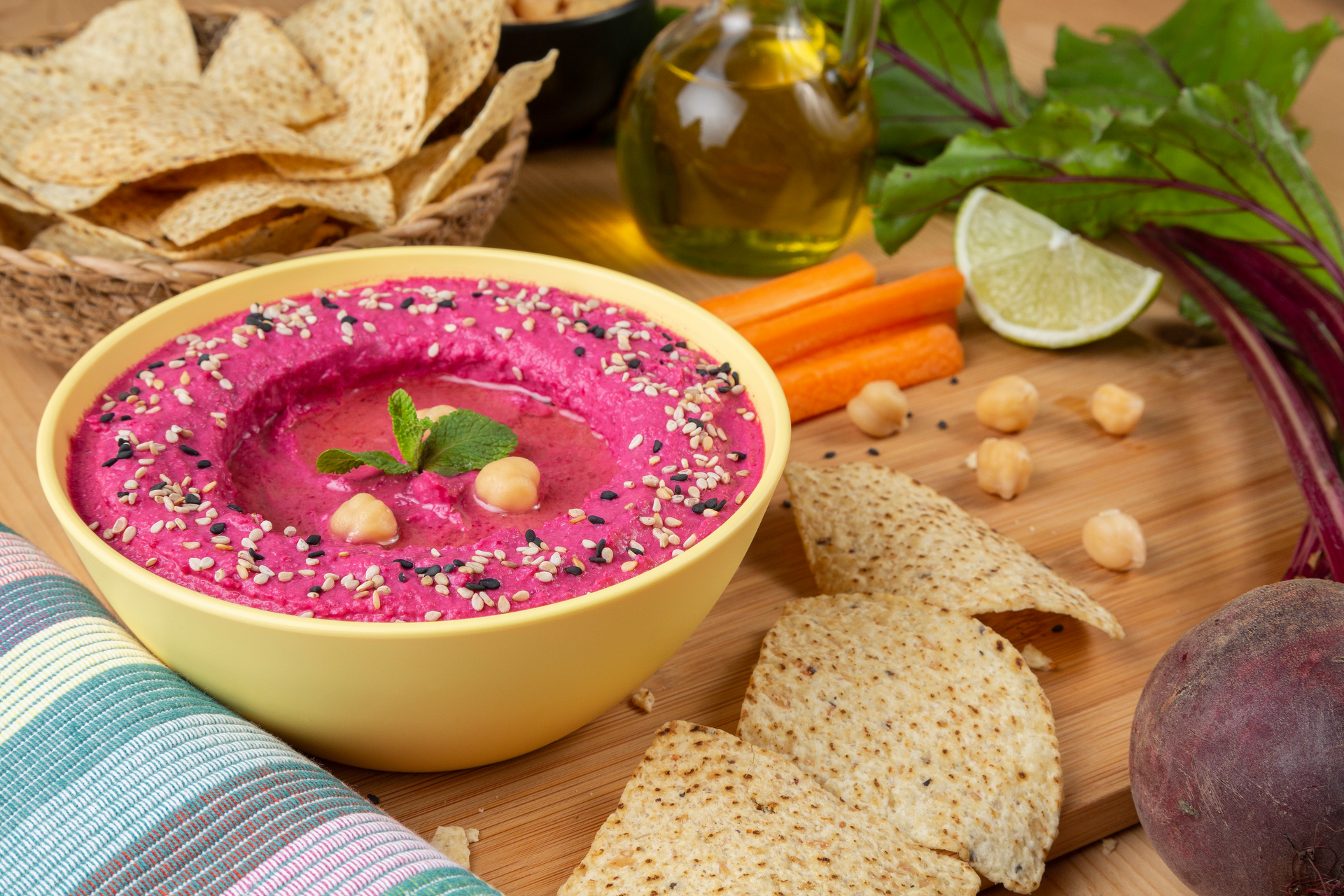 Overhead flat-lay of all ingredients for Za'atar Roasted Beet Hummus with Crunchy Chickpea Topping laid out on a kitchen surface.