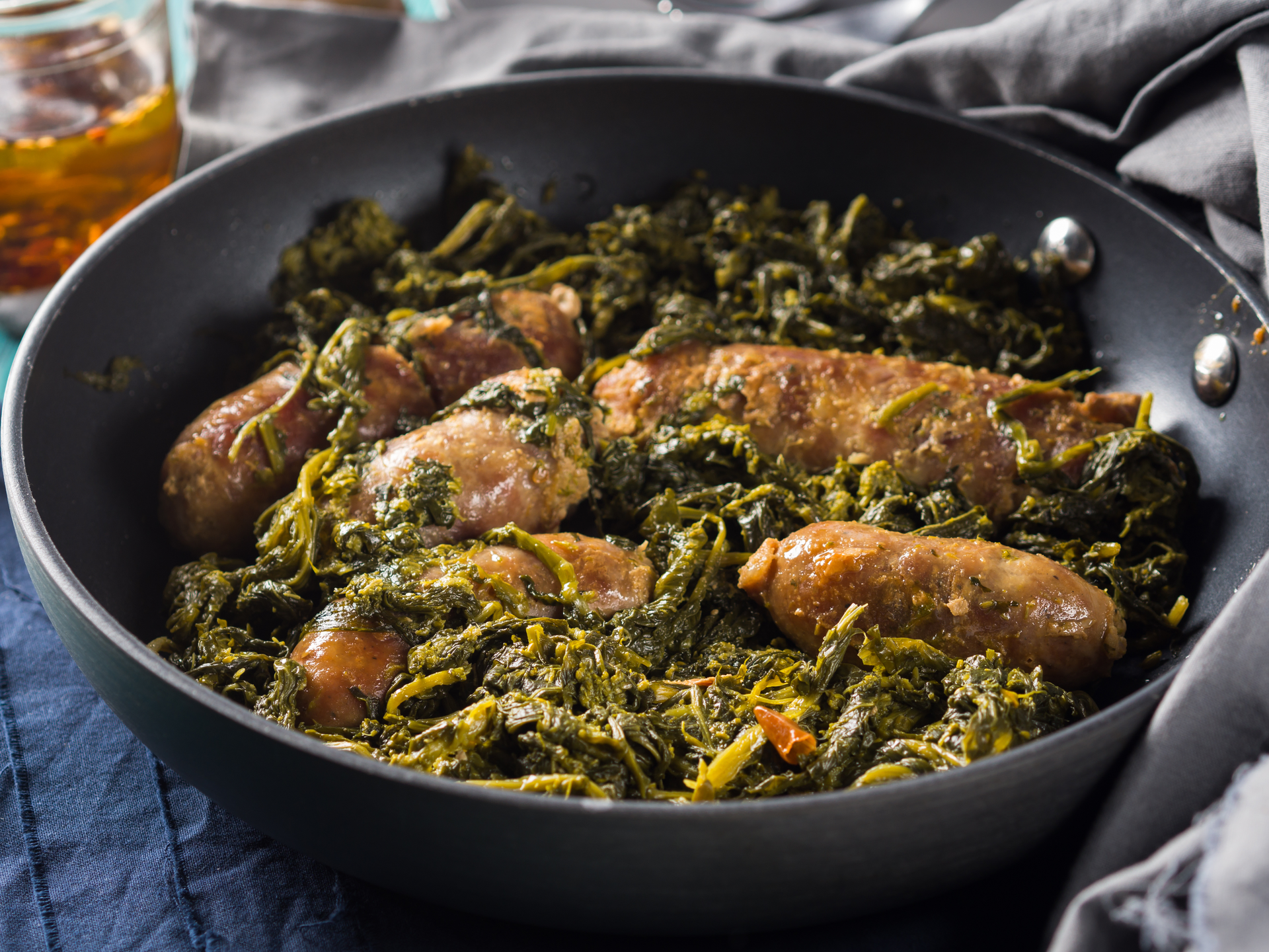 Overhead flat-lay of all ingredients for Zambian Nshima with Collard Greens and Grilled Tilapia laid out on a kitchen surface.