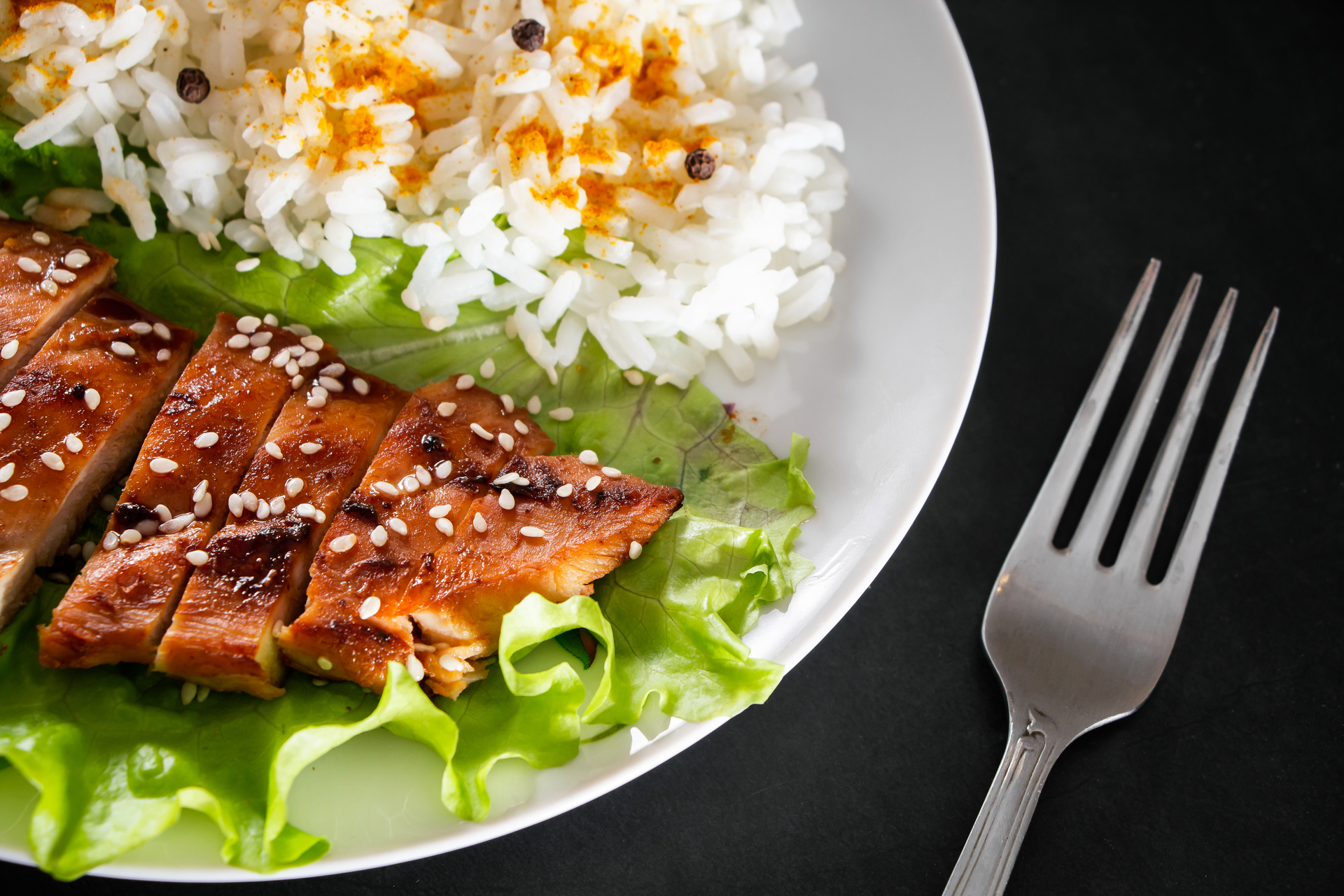 Overhead flat-lay of all ingredients for Zesty Asian Citrus-Cilantro Grilled Salmon with Jasmine Rice laid out on a kitchen surface.