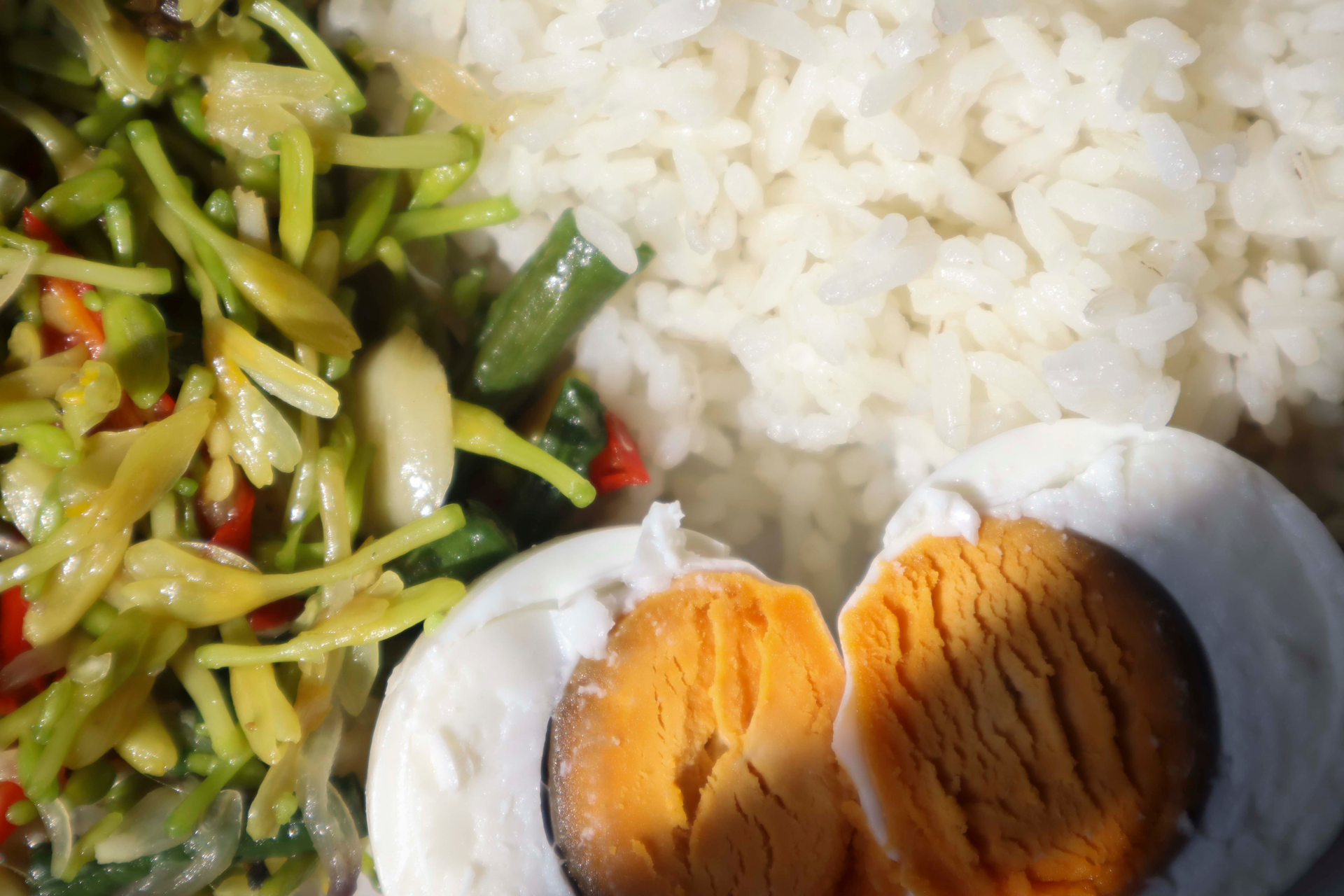 Overhead flat-lay of all ingredients for Zesty Balinese Nasi Campur with Coconut-Curry Infusion laid out on a kitchen surface.