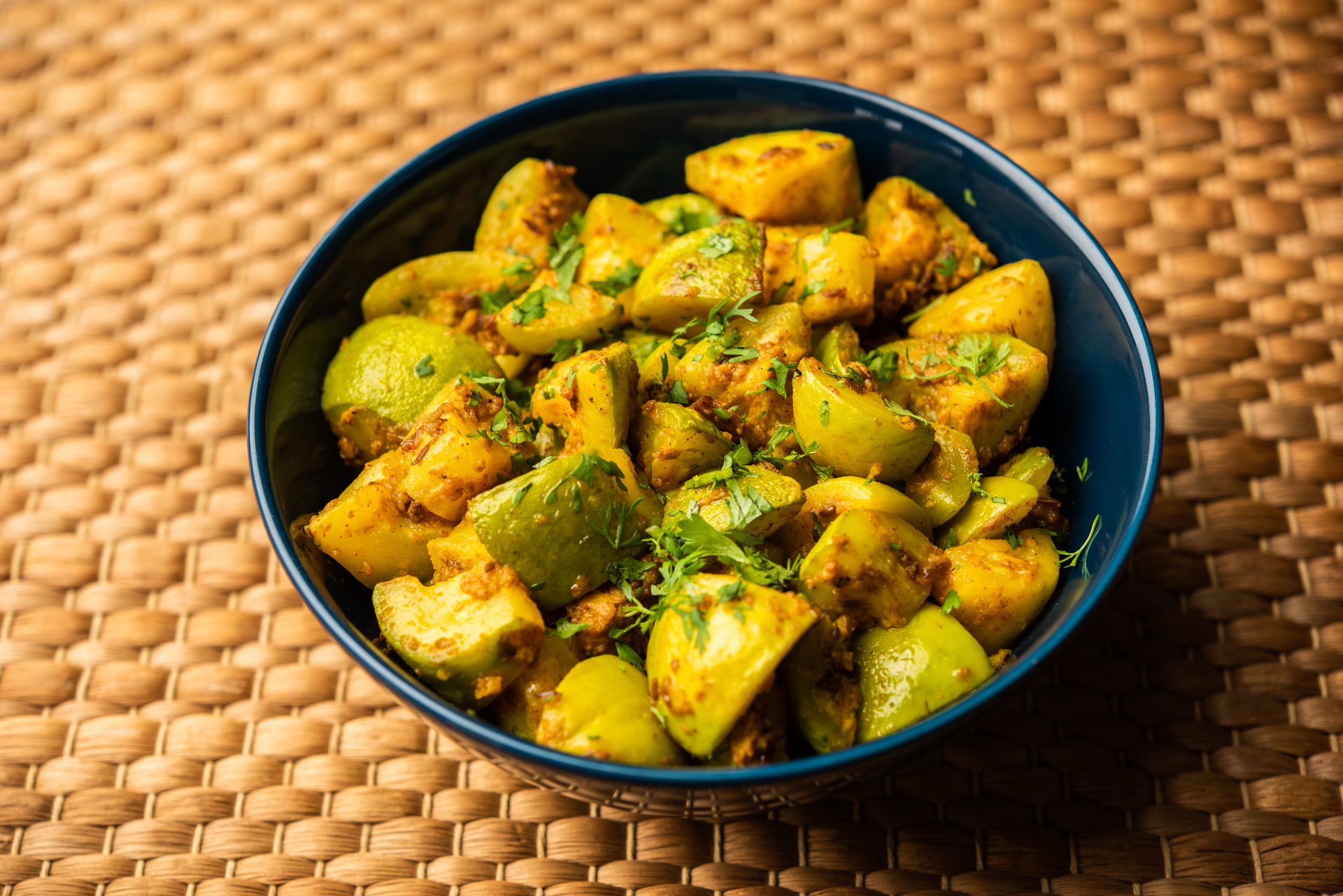 Overhead flat-lay of all ingredients for Zesty Bangladeshi Aloo Dum with Mustard Seeds laid out on a kitchen surface.