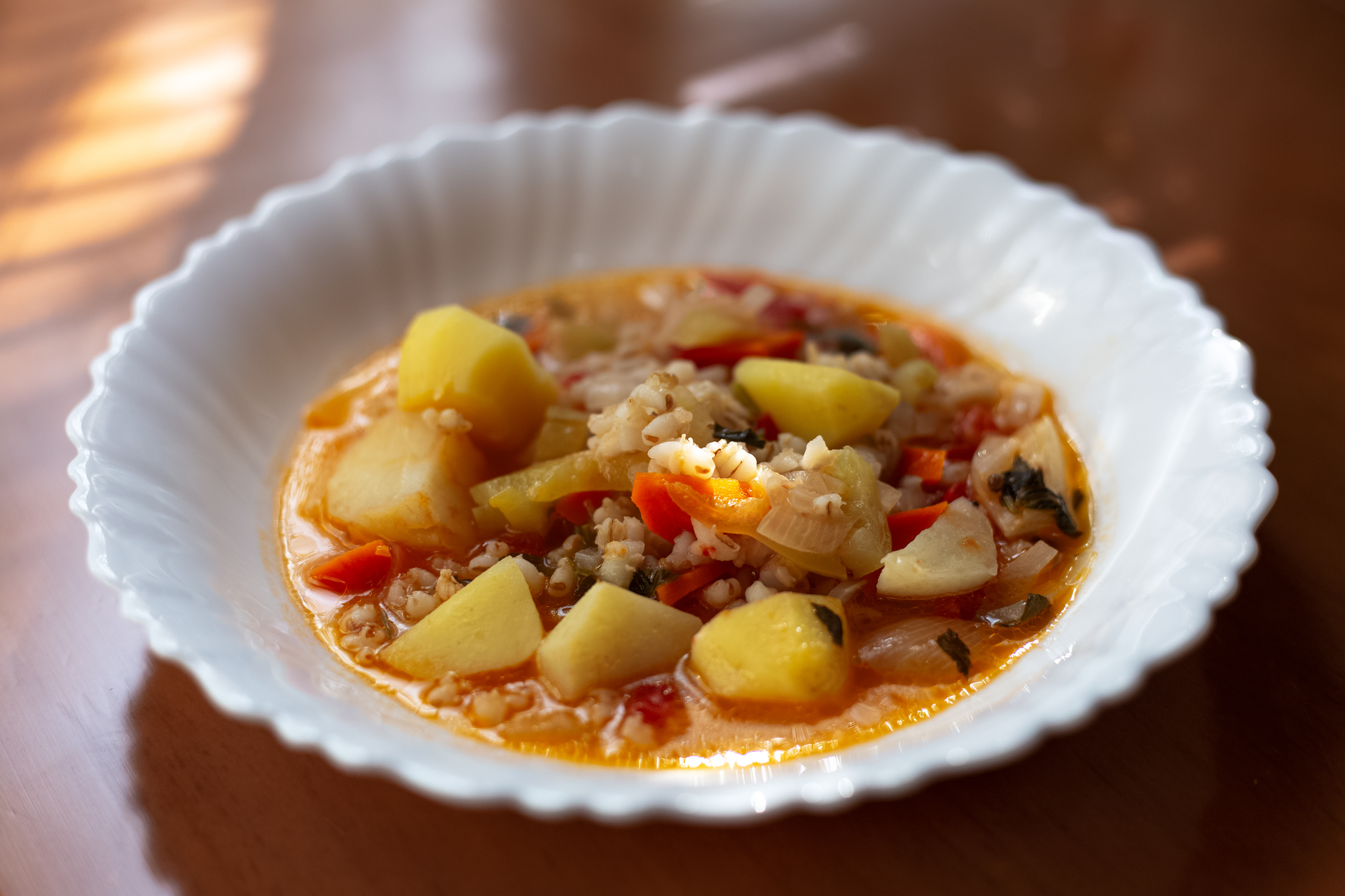 Overhead flat-lay of all ingredients for Zesty Caribbean Jerk Lentil Soup with Pineapple Chutney laid out on a kitchen surface.