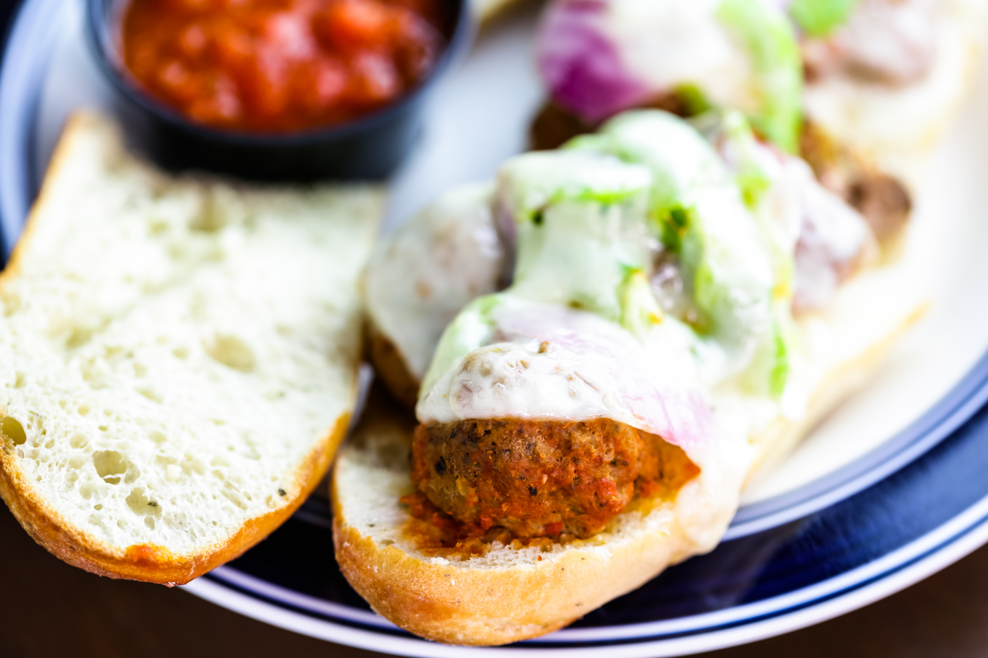 Overhead flat-lay of all ingredients for Zesty Ethiopian Seared Kitfo Sliders with Mitmita Mayo laid out on a kitchen surface.