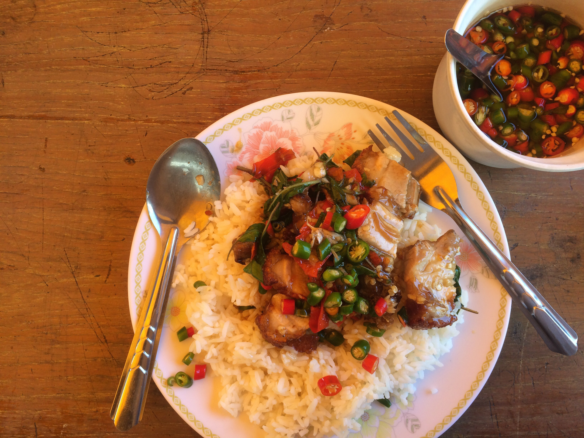 Overhead flat-lay of all ingredients for Zesty Haitian Griot with Pikliz and Rice laid out on a kitchen surface.