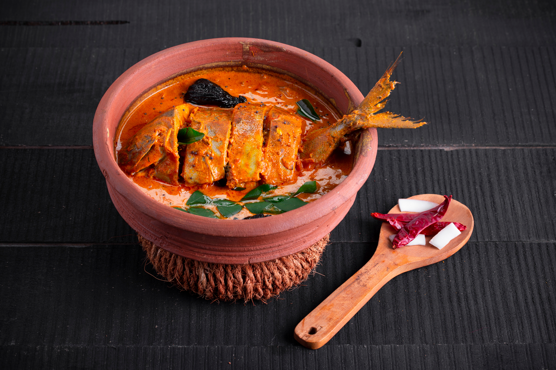 Overhead flat-lay of all ingredients for Zesty Indian Tamarind Fish Curry laid out on a kitchen surface.