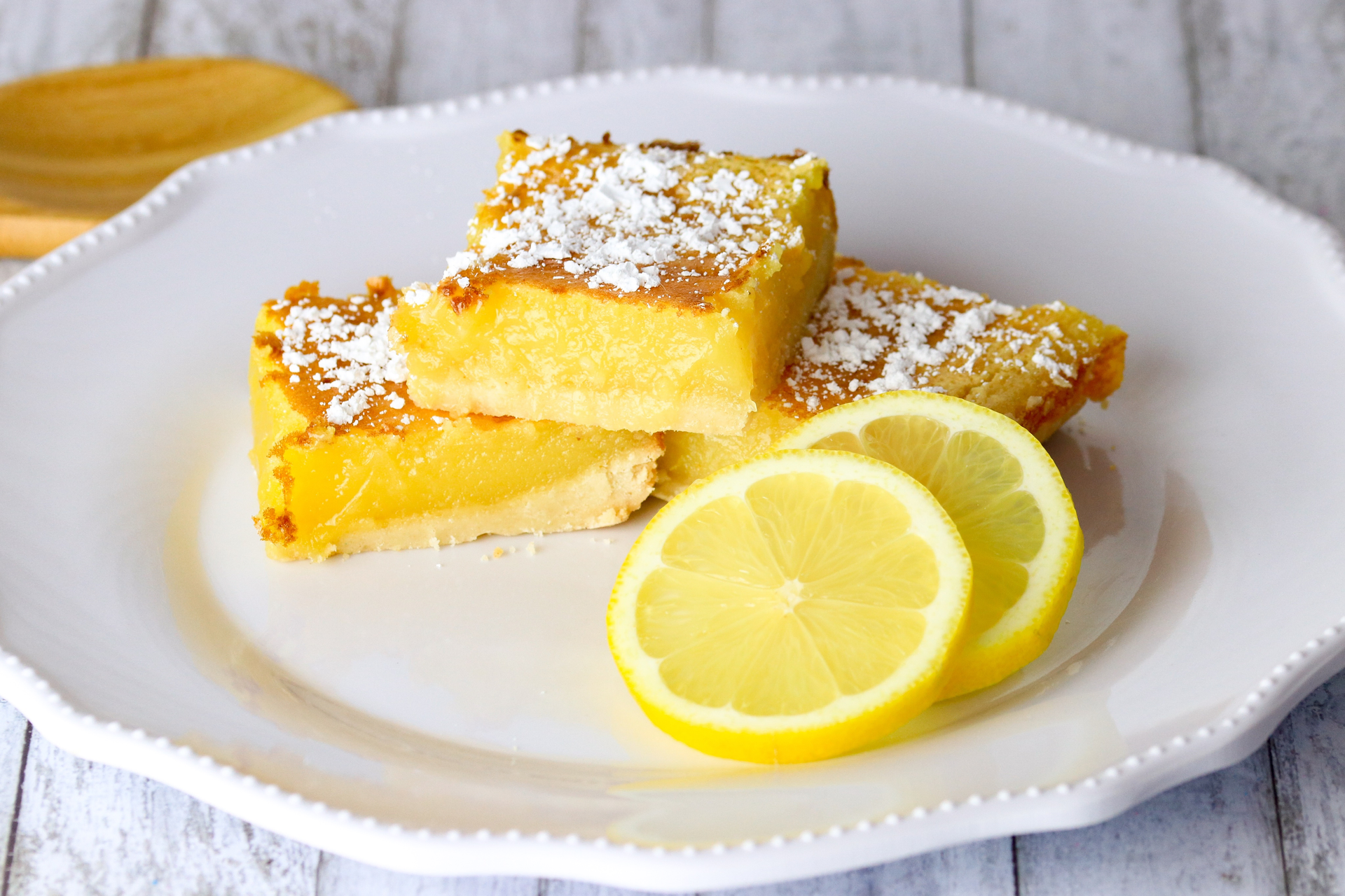 Overhead flat-lay of all ingredients for Zesty Italian Lemon Polenta Cake with Rosemary Syrup laid out on a kitchen surface.