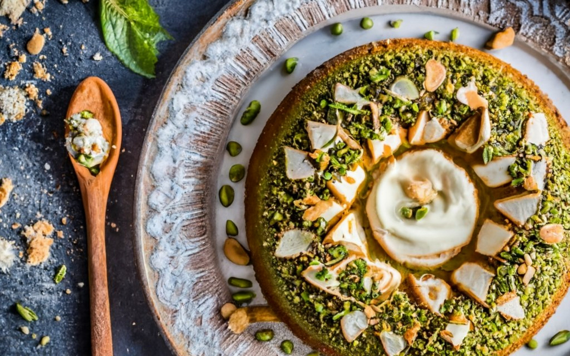 Overhead flat-lay of all ingredients for Zesty Lebanese Pine Nut Pesto Bowties with Minted Yogurt laid out on a kitchen surface.