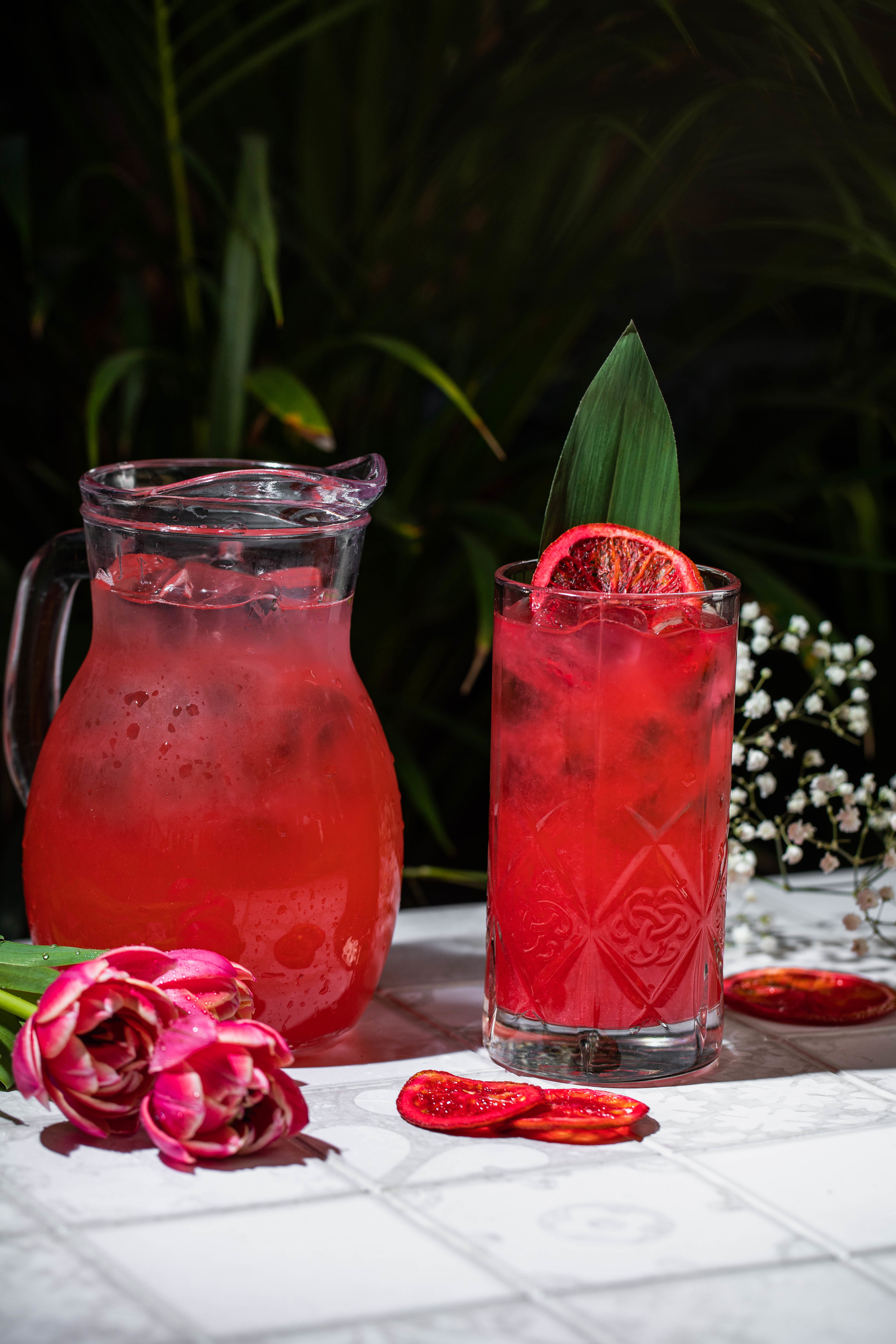 Overhead flat-lay of all ingredients for Zesty Mexican Agua de Jamaica with Hibiscus and Lime laid out on a kitchen surface.