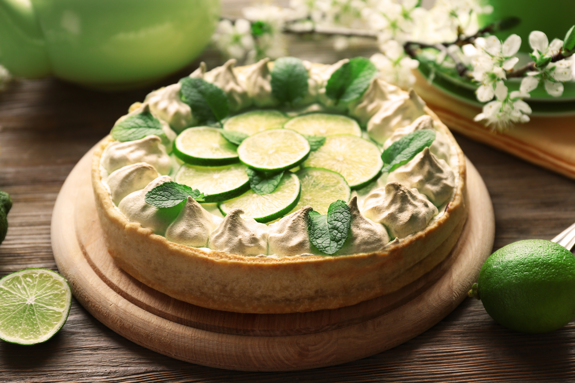 Overhead flat-lay of all ingredients for Zesty Mexican Lime and Avocado Tart with Tequila Whipped Cream laid out on a kitchen surface.