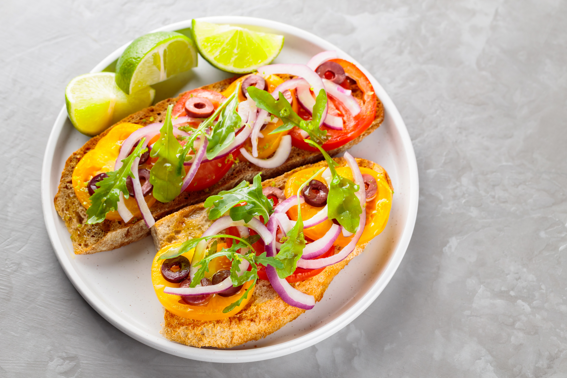 Overhead flat-lay of all ingredients for Zesty Mexican Tostadas with Citrus-Marinated Ceviche laid out on a kitchen surface.