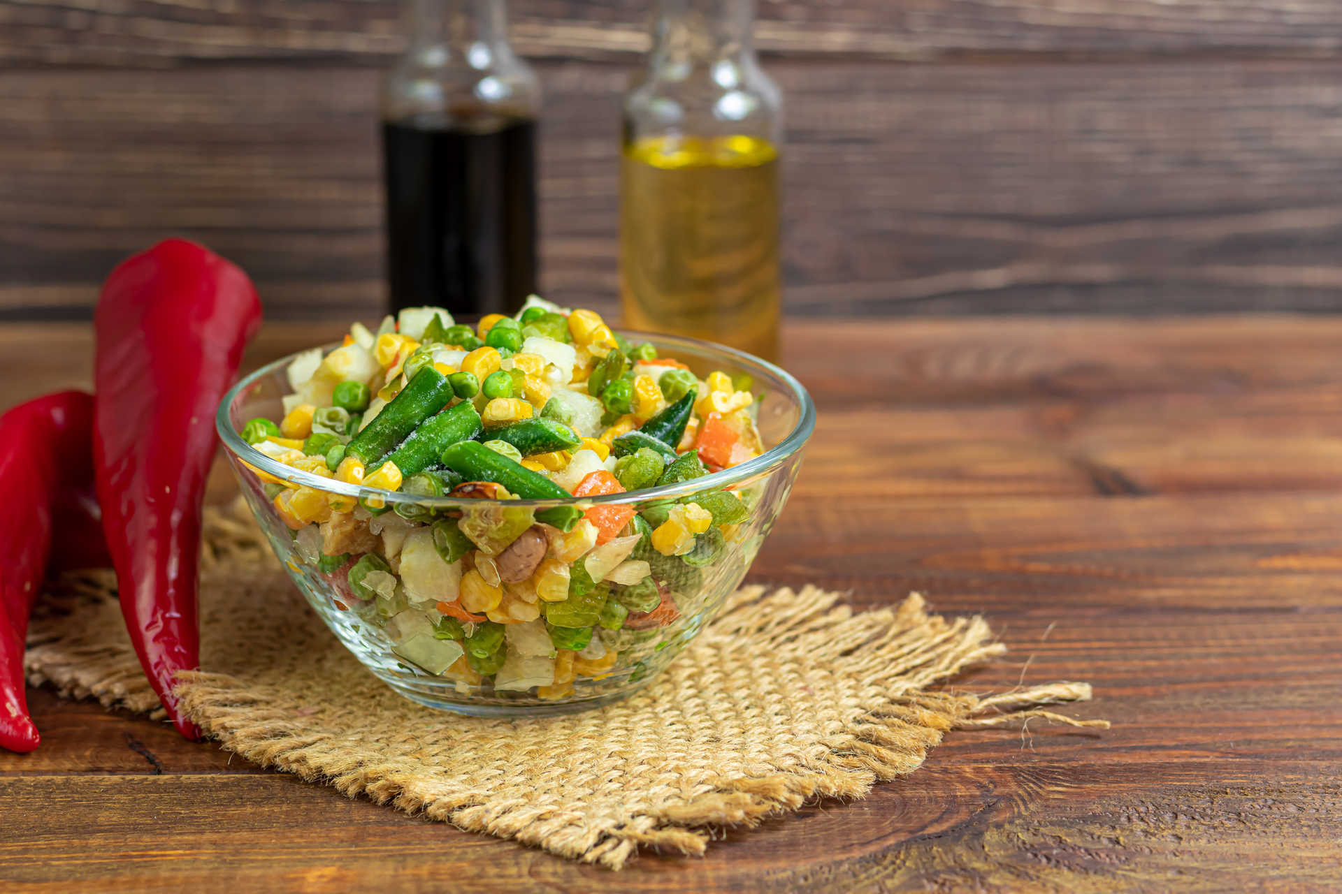 Overhead flat-lay of all ingredients for Zesty Peruvian Choclo Salad with Cilantro and Lime Dressing laid out on a kitchen surface.