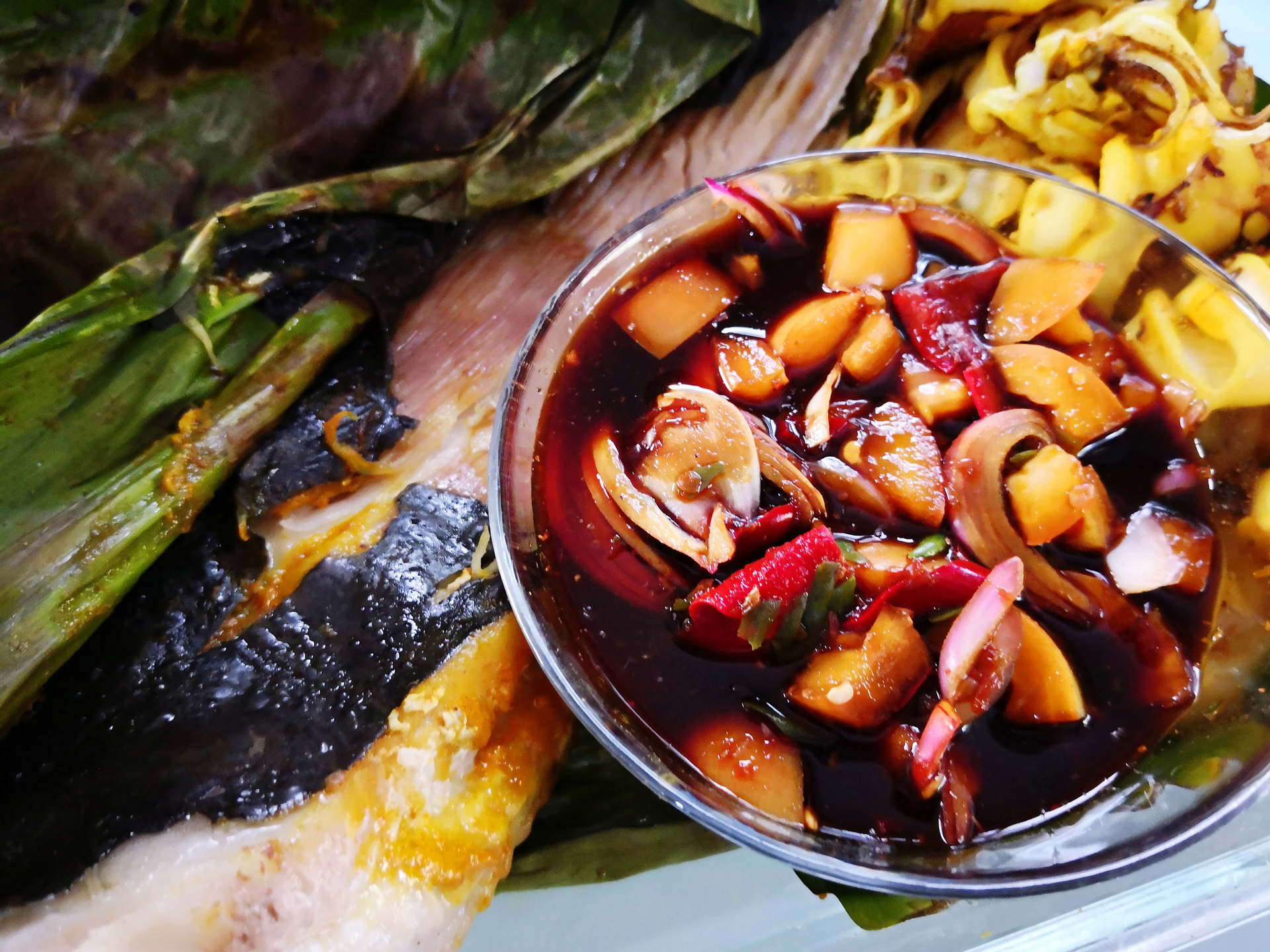 Overhead flat-lay of all ingredients for Zesty Singaporean Chili Sambal Squid with Pineapple Boat laid out on a kitchen surface.