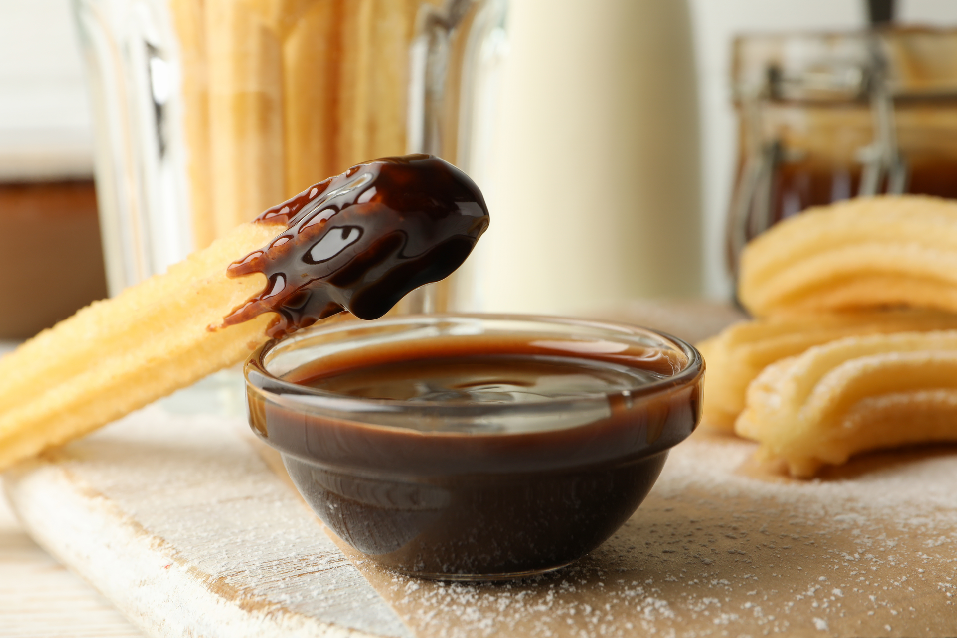 Overhead flat-lay of all ingredients for Zesty Spanish Churros with Chocolate Dipping Sauce laid out on a kitchen surface.