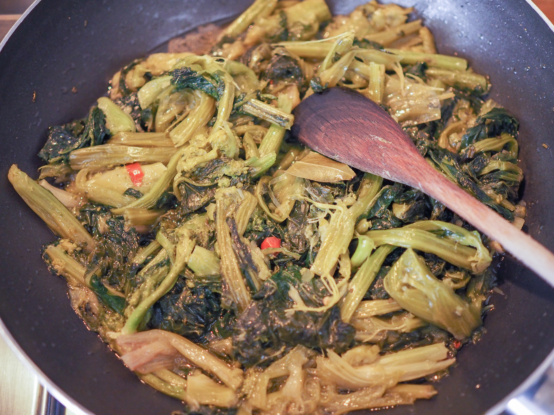Overhead flat-lay of all ingredients for Zimbabwean Peanut Butter Stew with Collard Greens laid out on a kitchen surface.